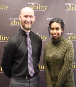 Michael Murray and RespectAbility Fellow Tameir Yeheyes in front of the RespectAbility banner