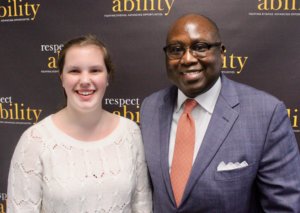 Rodney Hood and RespectAbility Fellow Emily Counts in front of the RespectAbility banner