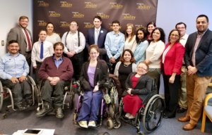 Geoffrey Melada and RespectAbility's Spring 2018 Fellows in front of the RespectAbility banner