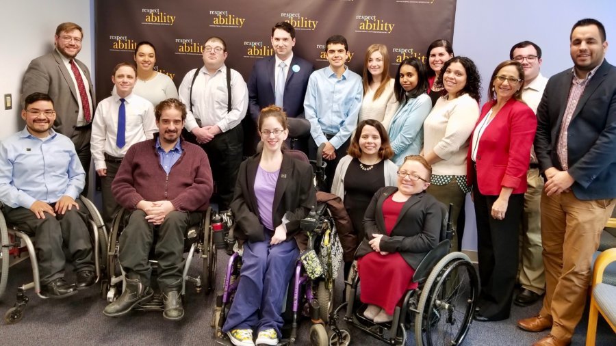 Geoffrey Melada and RespectAbility's Spring 2018 Fellows in front of the RespectAbility banner