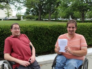 Photo of Justin Chappell and Ben Spangenberg, with Ben holding up a stack of papers