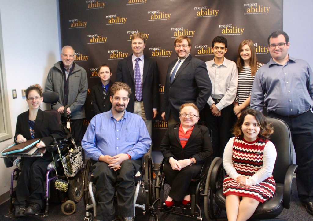 Derek Shields with RespectAbility staff and Fellows in front of the RespectAbility banner