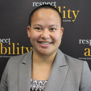 Headshot of Kaity in professional dress in front of the Respectability banner