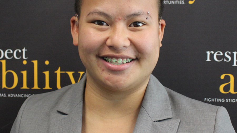 Headshot of Kaity in professional dress in front of the Respectability banner