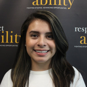 Daniela Nieves is smiling in front of the Respectability banner