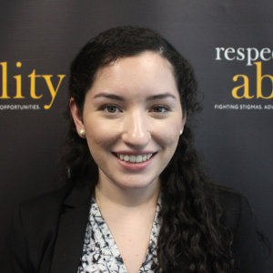 Mannela Iparraguirre is smiling in front of the Respectability banner 