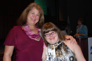 Debra Ruh and her daughter, Sara is smiling next to each other.