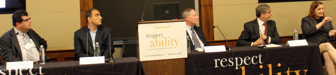 Donn Weinberg, Jim Sinocchi, Ron Painter, Vincenzo Piscopo and an ASL interpreter behind a table with RespectAbility's logo on it.