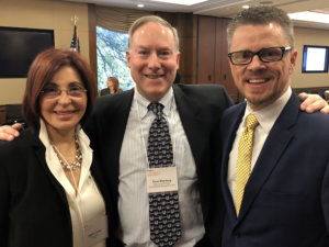 Judith Creed, Donn Weinberg and Johnny Collett smile together