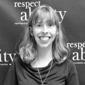 Emily Kranking smiling in front of the RespectAbility banner