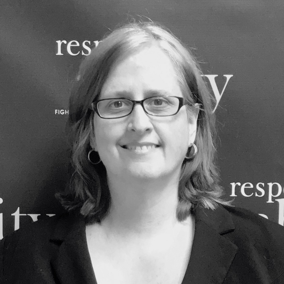 Kathleen L. Brockway smiling in front of the RespectAbility banner