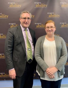 Andy Imparato and Emma Content in front of the RespectAbility banner