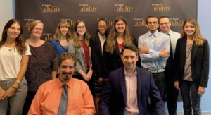 Geoffrey Melada and RespectAbility staff and Fellows in front of the RespectAbility banner