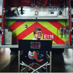 Gavin McHugh on the set of 9-1-1 in front of a firetruck