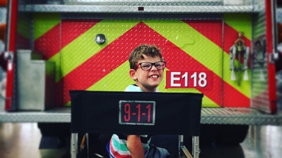 Gavin McHugh on the set of 9-1-1 in front of a firetruck