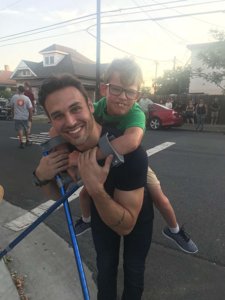 Gavin McHugh getting a piggy-back ride from his father on the set of 9-1-1