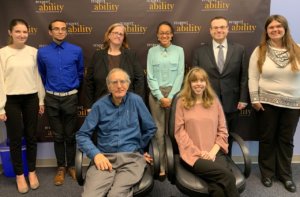 Bob Rudney with RespectAbility staff and Fellows in front of the RespectAbility banner