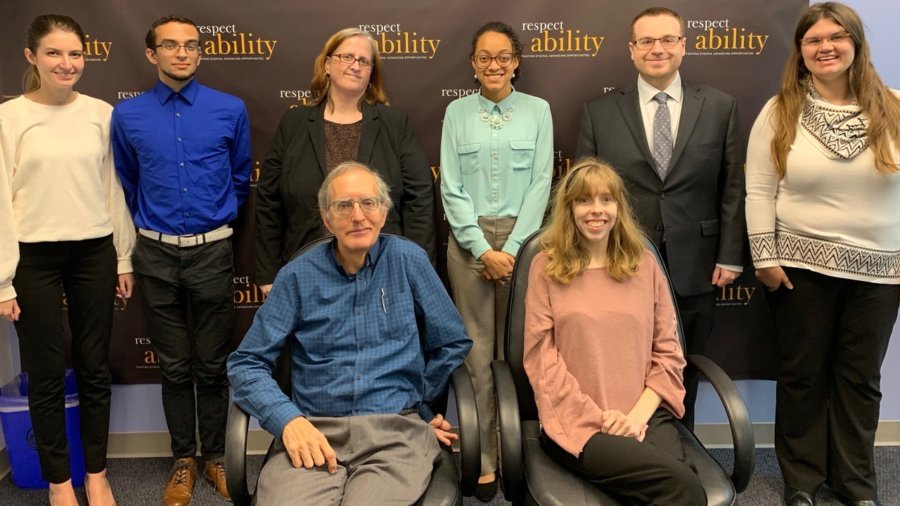 Bob Rudney with RespectAbility staff and Fellows in front of the RespectAbility banner