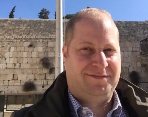 Eli Ovits in front of a wall in Israel