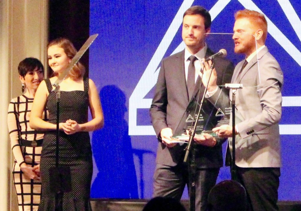 Scott Beck and Bryan Woods accepting their Media Access Award as Millicent Simmonds looks on