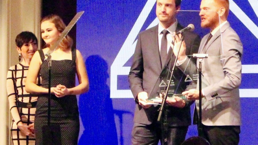 Scott Beck and Bryan Woods accepting their Media Access Award as Millicent Simmonds looks on