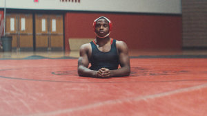 Zion in uniform on the mat in the gym