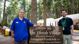 Howard Blas with a guest outside the Tikvah Village at Camp Ramah
