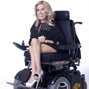 Dr. Danielle Sheypuk in a power wheelchair, smiling