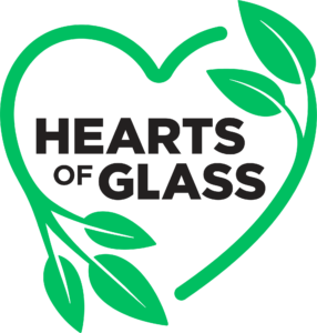 Hearts of Glass Logo, with green plants shaped like a heart surrounding text reading Hearts of Glass