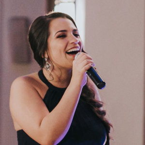 Amanda Lopez holding a microphone, singing