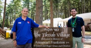 Howard Blas with a guest outside the Tikvah Village at Camp Ramah