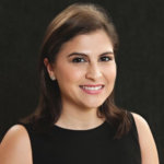 Jessica Palacios smiling in front of a black backdrop