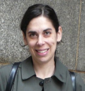 Dr. Jordana Mendelson smiling in front of a wall