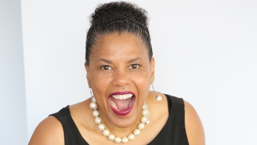 Donna Walton smiling in front of a white wall