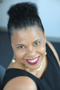 Donna Walton smiling in front of a blurred background