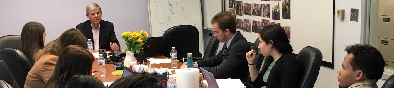 David Belkin speaks with RespectAbility Fellows, sitting around the conference room table