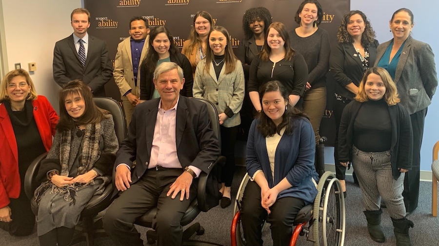 David Belkin with RespectAbility staff and Fellows in front of the RespectAbility banner