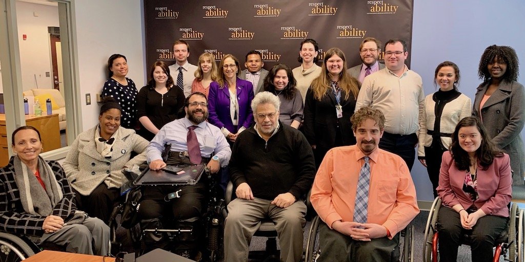 Steve Rabinowitz with RespectAbility Staff and Fellows in front of the RespectAbility banner