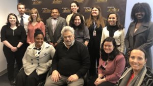 Steve Rabinowitz with RespectAbility Fellows in front of the RespectAbility banner