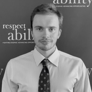 Jeremy Cooper in front of the RespectAbility banner