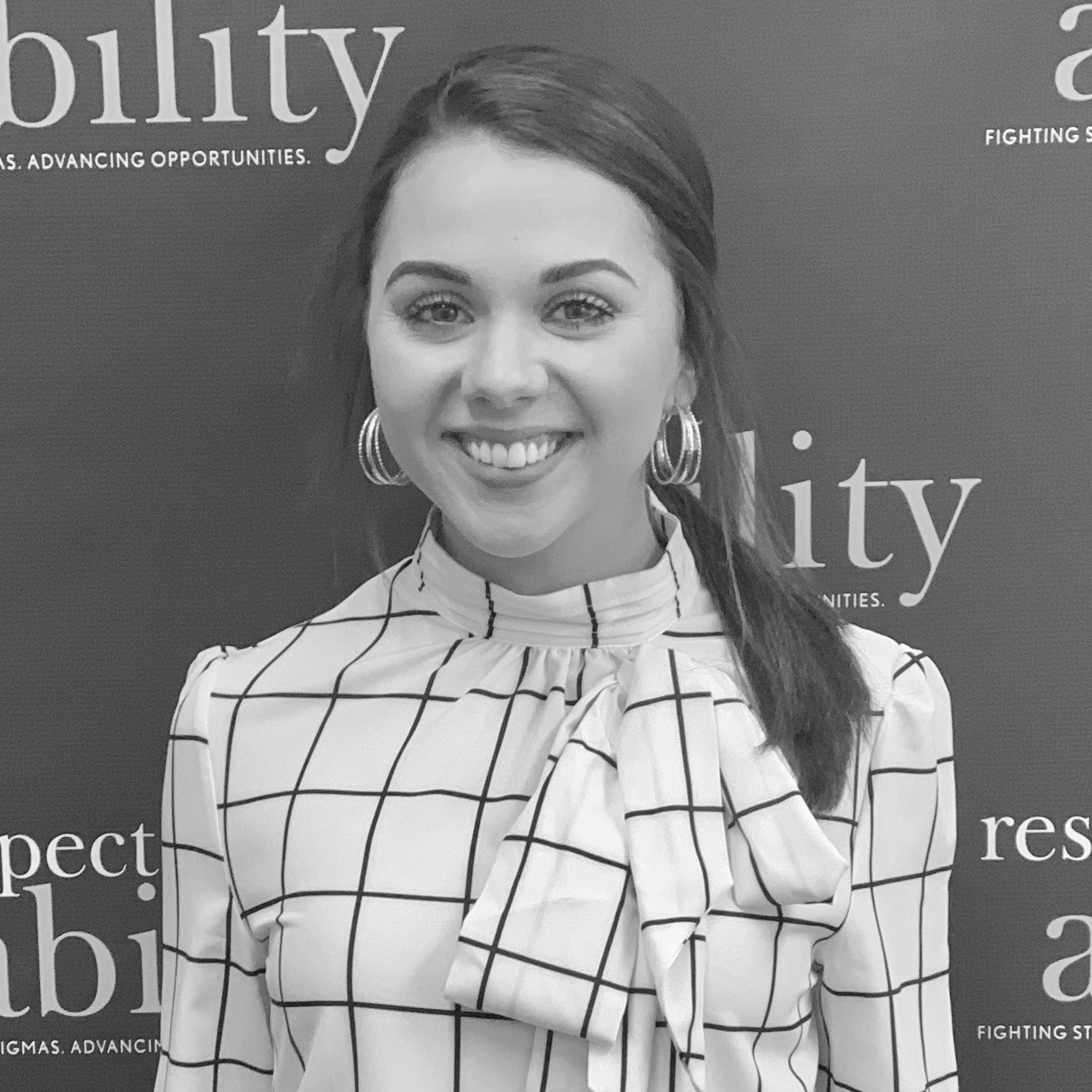 Vivian O'Neal smiling in front of the RespectAbility banner