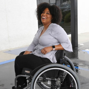 Tatiana Lee smiling outside in a parking lot.