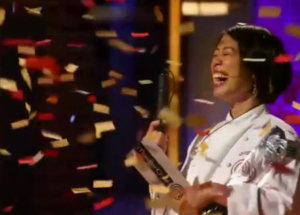 Christine Ha holds her MasterChef trophy as confetti falls around her