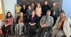 Linda Burger with RespectAbility staff and Fellows in front of the RespectAbility banner