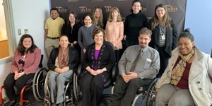 Linda Burger with RespectAbility staff and Fellows in front of the RespectAbility banner