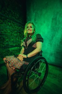 Ali Stroker smiling in front of green walls