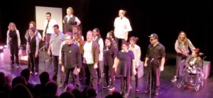 23 cast members, most who have Autism, singing on stage