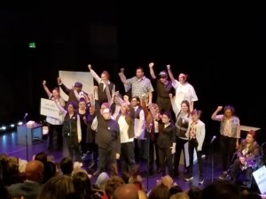 23 cast members, most who have Autism, singing on stage