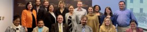 Neil Romano with RespectAbility staff and Fellows in front of the RespectAbility banner