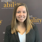 Jolie Carr smiling in front of the RespectAbility banner